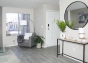 Thumbnail 6 of 25 - a living room with a couch and a mirror and a fireplace