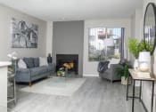 Thumbnail 1 of 25 - a living room with grey couches and a fireplace