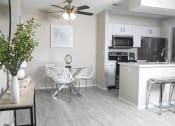 Thumbnail 4 of 25 - an open kitchen and living room with a dining room table and chairs and a kitchen
