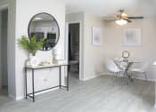 Thumbnail 2 of 25 - a living room with a mirror and a dining room table