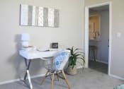Thumbnail 9 of 25 - a home office with a desk and a chair and a potted plant