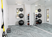 Thumbnail 22 of 37 - A room with a grey carpet and a yellow exercise equipment.