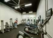 Thumbnail 7 of 25 - Fitness Center with Cardio Equipment, Overhead Ceiling Fan, and Windows on the Far Wall at Enclave at Paradise Valley, Phoenix, AZ