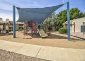 Thumbnail 14 of 25 - a playground with a swing set and slides in a courtyard