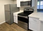 Thumbnail 11 of 18 - a kitchen with stainless steel appliances and white cabinets at Stonebridge, Phoenix