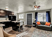 Thumbnail 6 of 12 - a living room with a couch and a kitchen