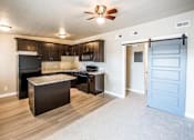 Thumbnail 2 of 12 - a kitchen with an island and a blue door