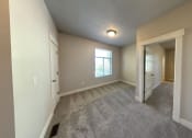 Thumbnail 3 of 14 - an empty living room with a closet and a window
