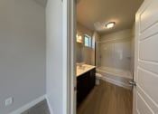 Thumbnail 9 of 14 - an empty bathroom with a shower toilet and sink