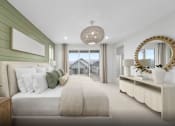 Thumbnail 28 of 28 - A bedroom with a large bed and a mirror on the wall.