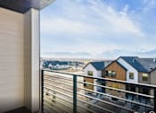 Thumbnail 24 of 28 - A balcony view of a snowy mountain range.