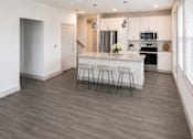 Thumbnail 5 of 25 - Modern kitchen island with bar seating at Avion at West Lemmon Apartments, Dallas, 75235