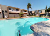 Thumbnail 10 of 11 - a large swimming pool with apartments in the background