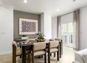 Thumbnail 22 of 24 - A dining room with a table set for four.