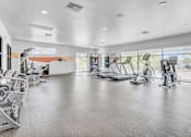 Thumbnail 15 of 24 - A spacious gym with a variety of exercise equipment.