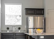 Thumbnail 6 of 17 - Kitchen with stainless steel refrigerator at The Village at Church & Main, Layton, 84041