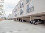 Thumbnail 22 of 25 - Covered parking garage with residential units above at Avion at West Lemmon Apartments, Dallas, Texas