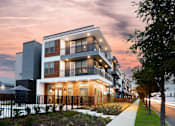 Thumbnail 1 of 25 - Modern apartment building exterior at dusk at Avion at West Lemmon Apartments, Dallas