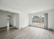 Thumbnail 11 of 26 - A large empty room with a view of a street outside.