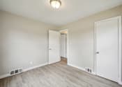 Thumbnail 23 of 26 - A room with white doors and a light on the ceiling.