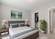 Thumbnail 5 of 29 - A bedroom with a large bed and a painting on the wall.
