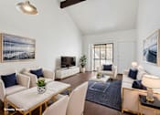 Thumbnail 4 of 29 - A living room with a white couch and a coffee table.