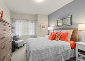 Thumbnail 8 of 12 - a bedroom with a bed and a dresser