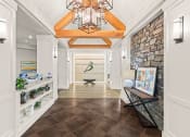 Thumbnail 1 of 12 - a long hallway with a stone wall and a vaulted ceiling with a light fixture
