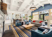 Thumbnail 3 of 12 - a living room with blue furniture and a fireplace