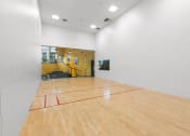 Thumbnail 6 of 15 - a basketball court in the center of a white room with wood floors and a yellow