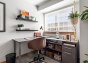 Thumbnail 13 of 15 - a home office with a desk and a window