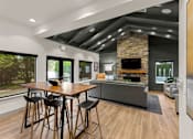 Thumbnail 4 of 15 - A modern dining room with a wooden table and chairs.
