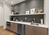 Thumbnail 2 of 15 - A modern kitchen with a stainless steel dishwasher and wooden cabinets.