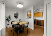 Thumbnail 9 of 15 - A dining room with a round table and chairs.