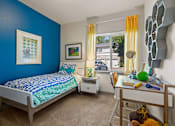 Thumbnail 11 of 12 - A bedroom with blue walls and a bed with a blue and white comforter.