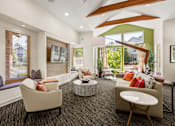 Thumbnail 1 of 12 - A living room with a large window and a view of a house.