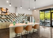 Thumbnail 11 of 27 - a kitchen with a counter and three chairs