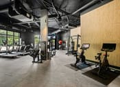 Thumbnail 13 of 27 - a workout room with treadmills and other exercise equipment