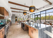 Thumbnail 19 of 27 - a large kitchen with a large island and a dining area