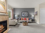 Thumbnail 7 of 12 - a living room with a fireplace and a couch