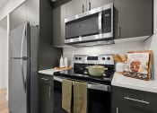 Thumbnail 5 of 27 - a kitchen with stainless steel appliances and a microwave