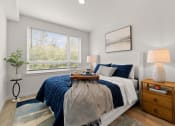 Thumbnail 6 of 27 - a bedroom with a bed and two windows