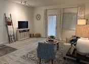Thumbnail 6 of 17 - A living room with a blue chair and a television.