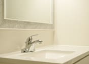 Thumbnail 25 of 31 - A white sink with a silver faucet in a bathroom.