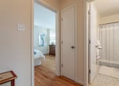 Thumbnail 17 of 31 - A white door is open to a room with a bed and a painting.