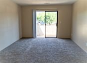 Thumbnail 8 of 22 - an empty living room with a door to a patio at Cowell Terrace Apartments, Concord, CA 94518