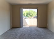Thumbnail 9 of 22 - an empty living room with a door to a balcony at Cowell Terrace Apartments, Concord, CA