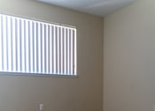 Thumbnail 2 of 22 - an empty room with a window and a carpeted floor at Cowell Terrace Apartments, Concord, CA