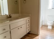 Thumbnail 21 of 22 - an empty bathroom with a sink and a toilet at Cowell Terrace Apartments, California, 94518