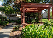 Thumbnail 1 of 22 - a pavilion in a park with plants and trees at Cowell Terrace Apartments, Concord, CA 94518